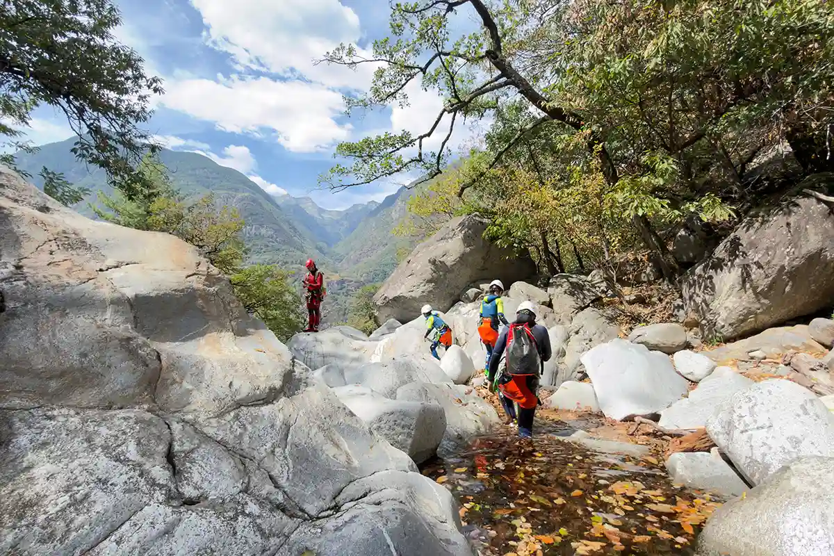 Family walking in the Boggera gorge whilst on a Canyoning Tour in Ticino